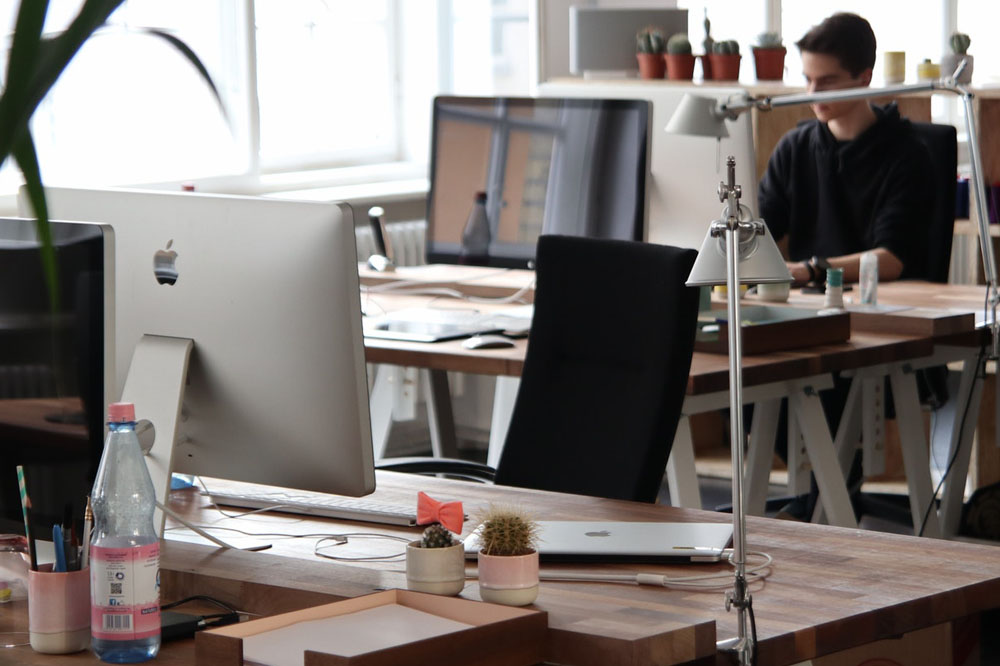 A man sitting at a desk, focused on his work.