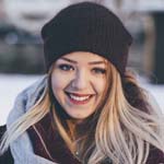 Woman smiling in snowy landscape.